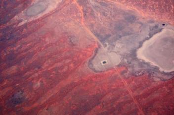 Roads and a small dam can be seen next to dried-up lakes located in outback Australia